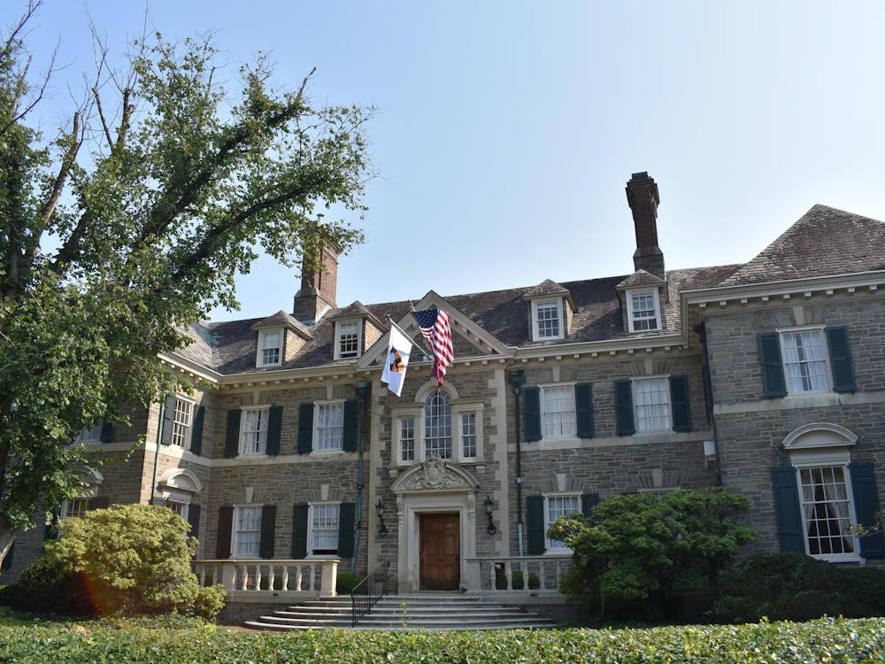 Front view of charter club, a three-story mansion with a grey stone exterior.