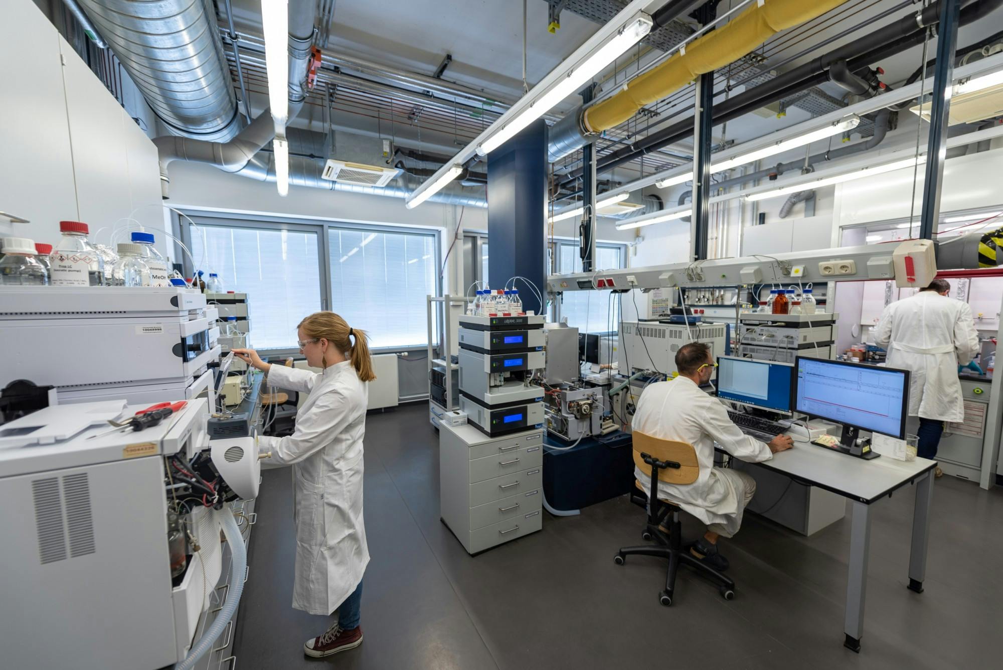 People working in a lab with advanced tech.