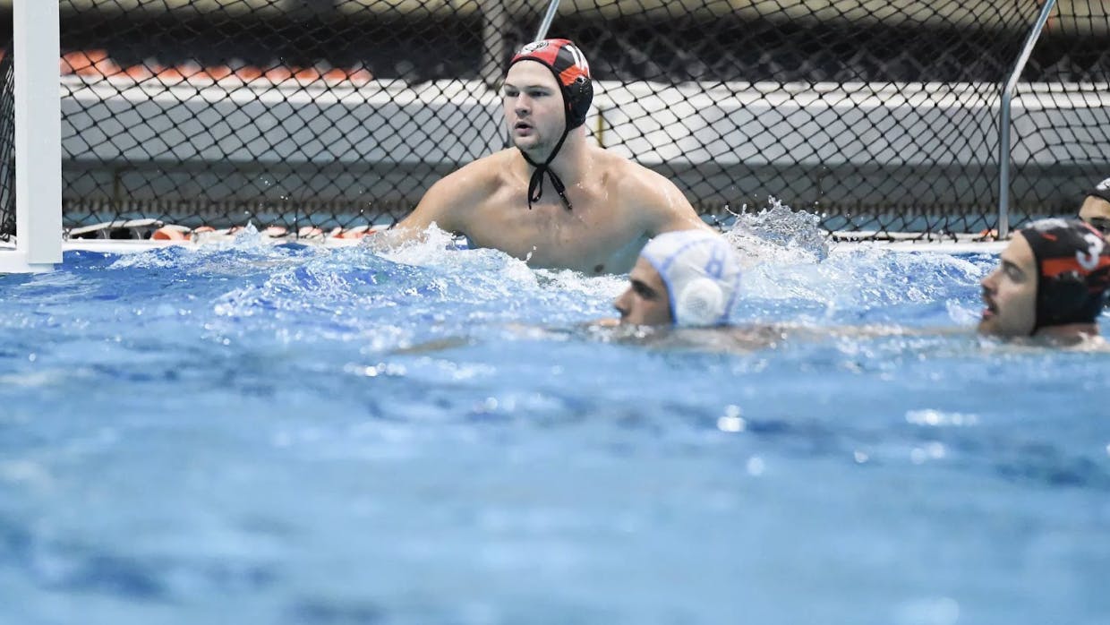 Waterpolo players swim in pool