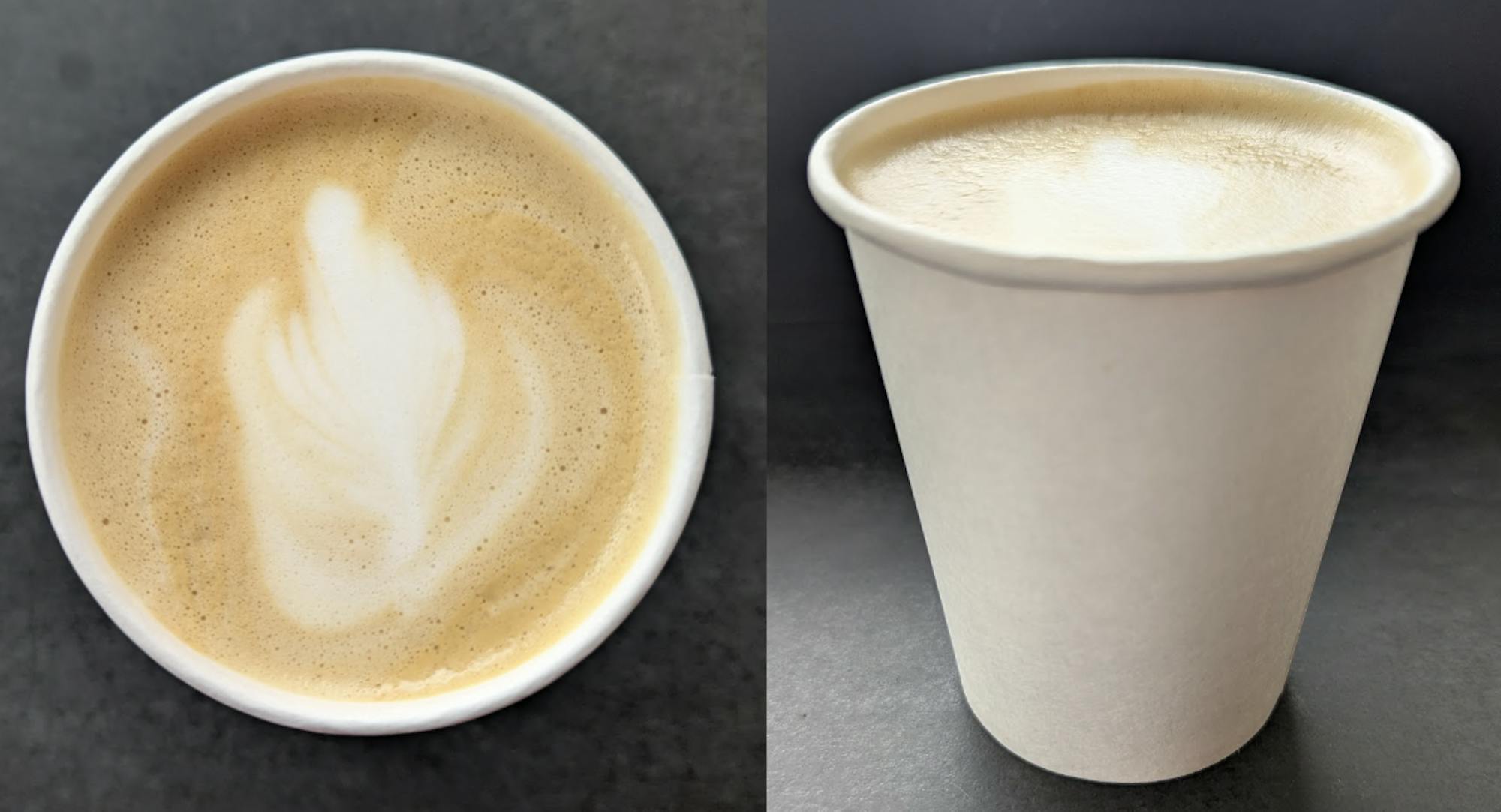 A light brown and white swirl of foam is at the top of a white cup against a gray background.