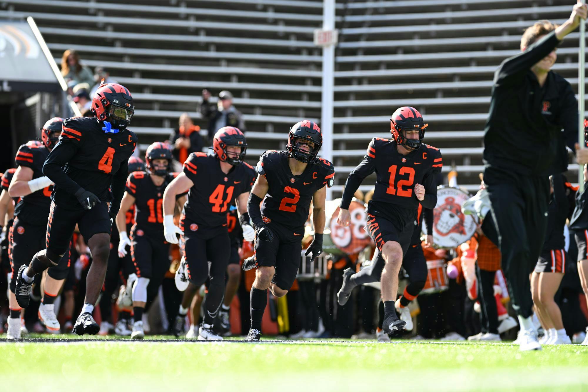 Princeton football players in black uniforms.