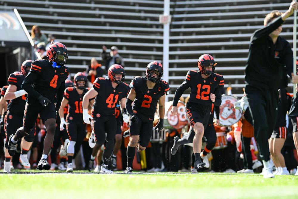 Princeton football players in black uniforms.