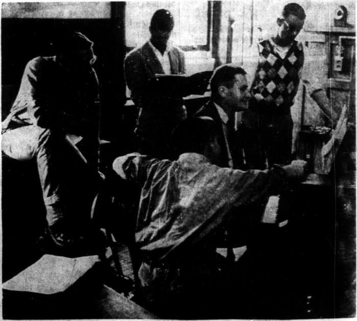 A black and white photo of five Princeton students attending class without ties and jackets.