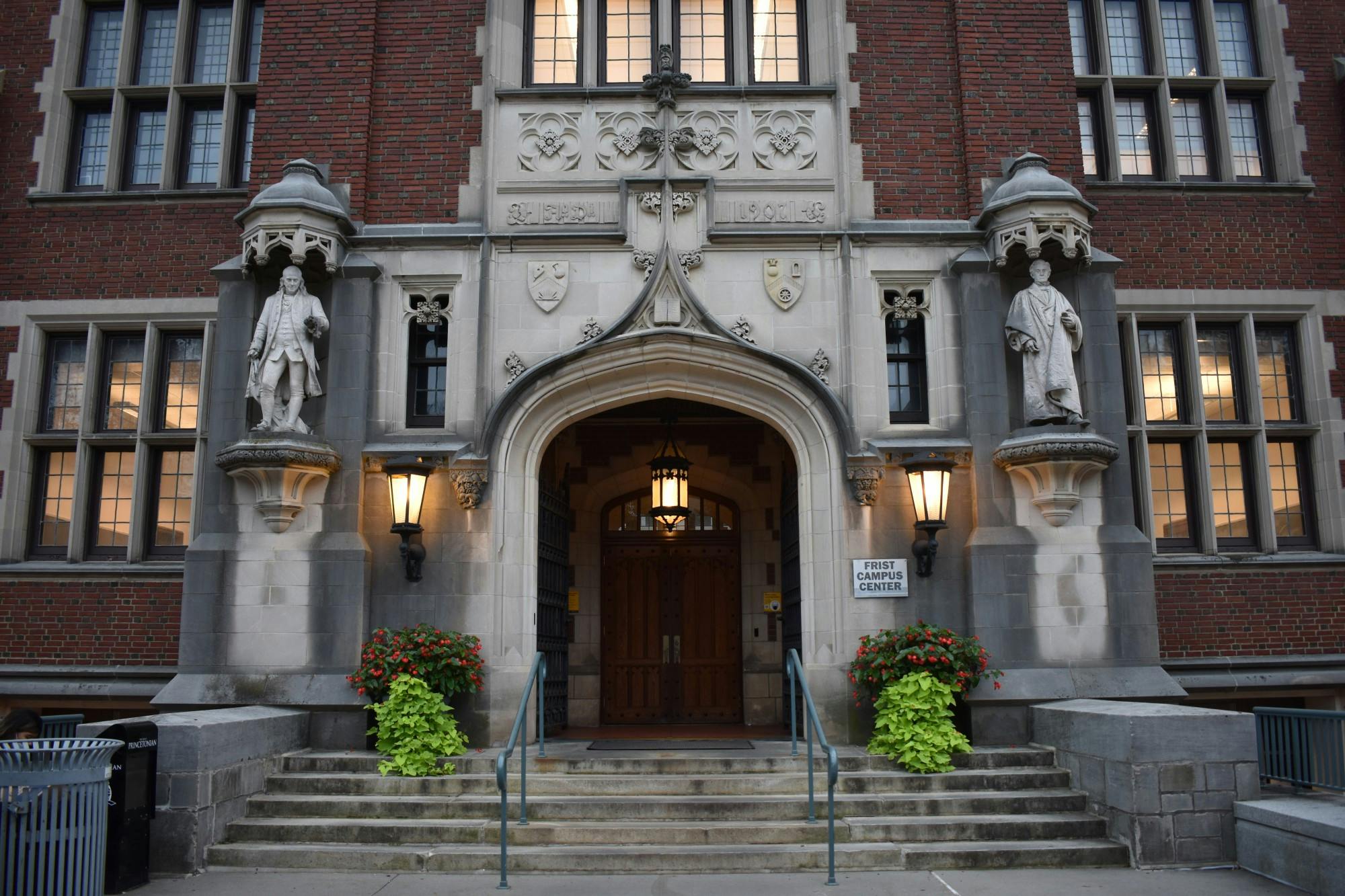 The North Lawn entrance of the Frist Campus Center. Pictured are wooden double doors recessed into a decorative concrete entrance.