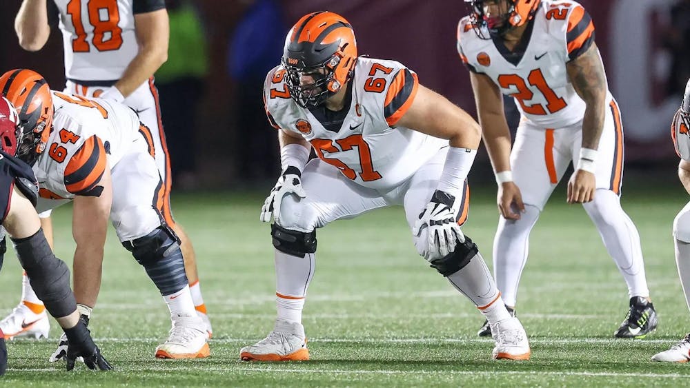 Man crouching on football field.