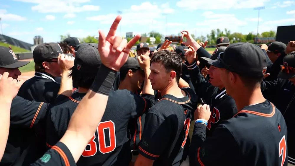Players in black jerseys huddle together.