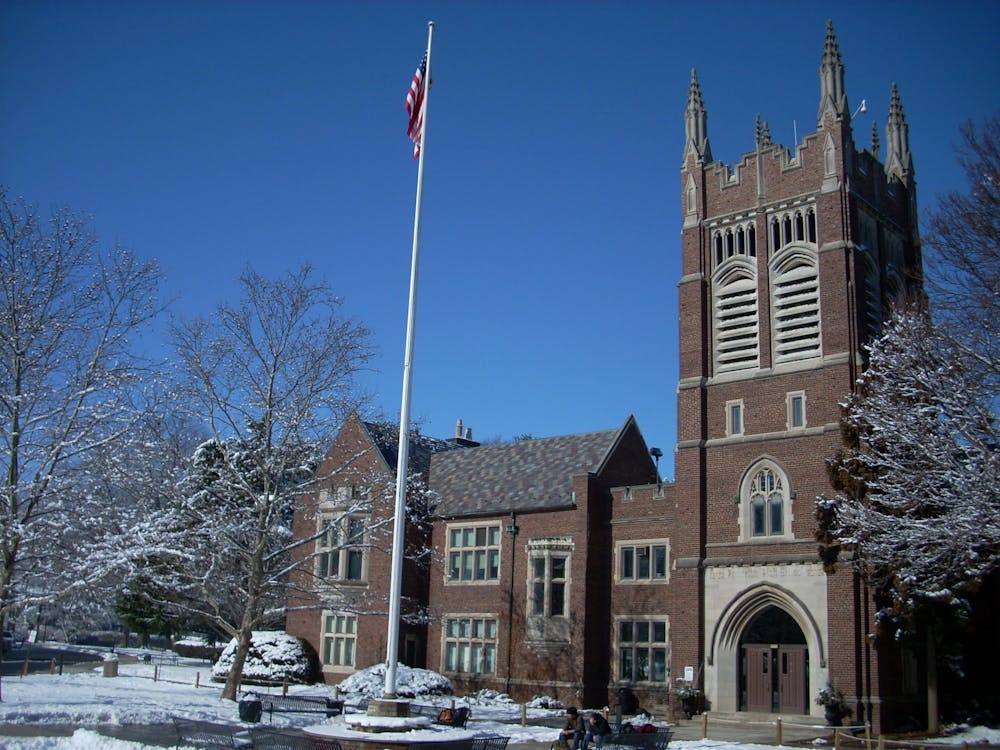 A red-brick schoolhouse on a snowy winter day.