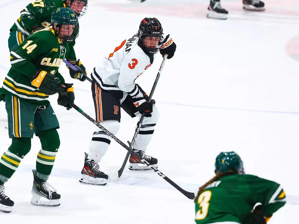Three women with a ice-hockey stick during a hockey game