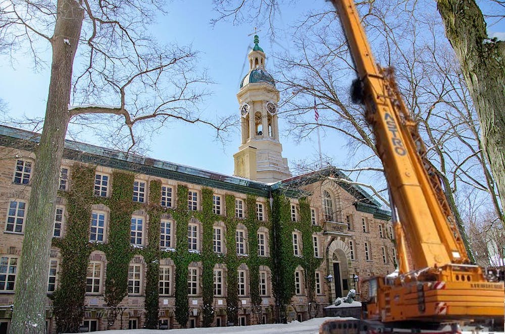 <h5>Construction teams prepare to lift Nassau Hall from it’s foundation, take it for a spin around campus, and return it to where it began.</h5>
<h6>Nate Beggs / The Daily Princetonian</h6>