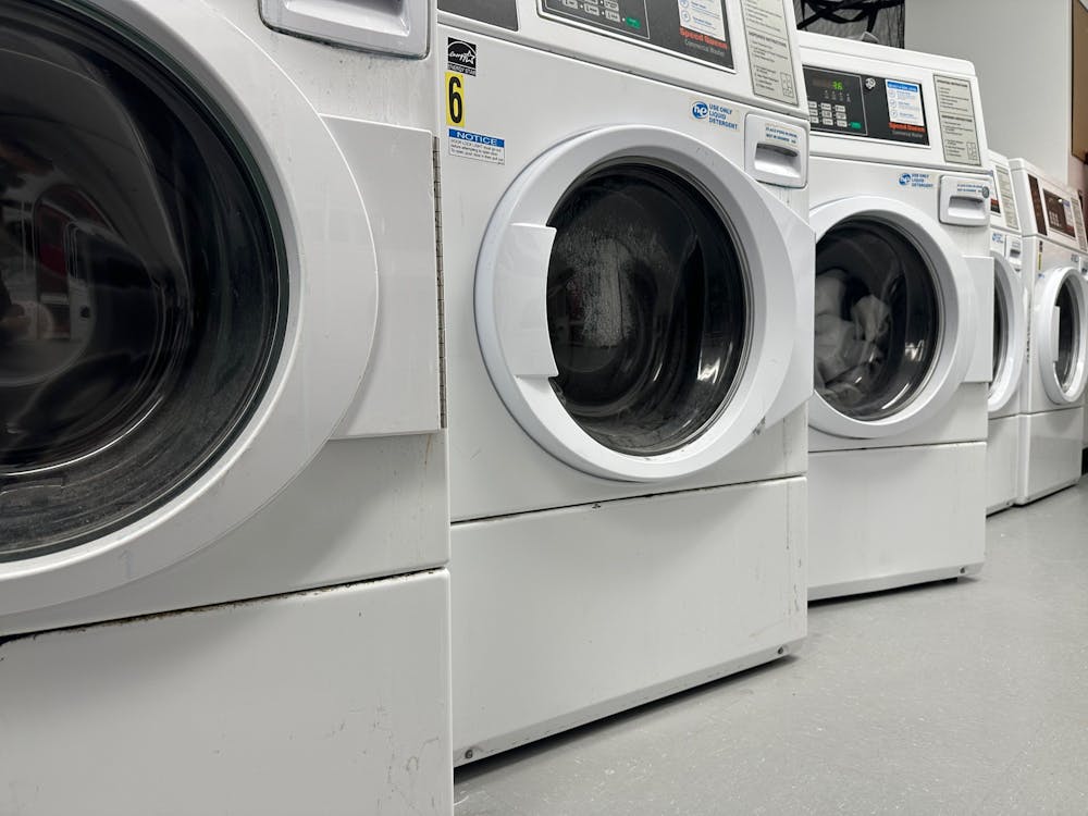 Five washing machines at varying angle, from a side view