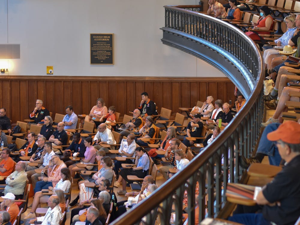 Adults congregate in McCosh 50, filling in almost every seat available.