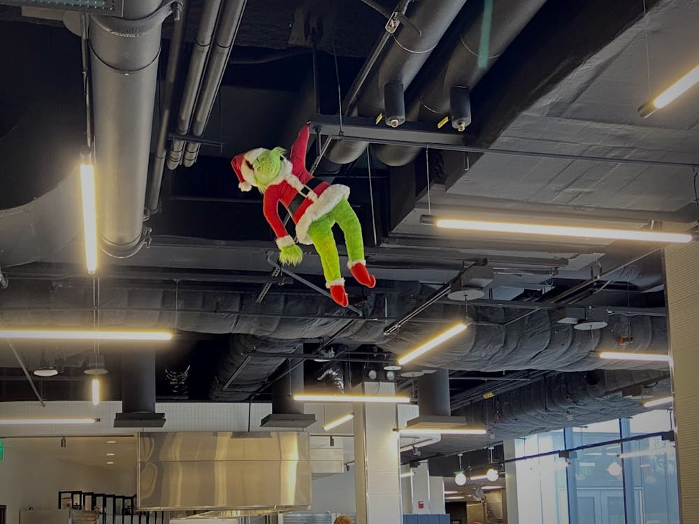 <h5>The Grinch cheerfully grins from the ceiling of the New College West dining hall.</h5>
<h6>Natalia Maidique / The Daily Princetonian</h6>