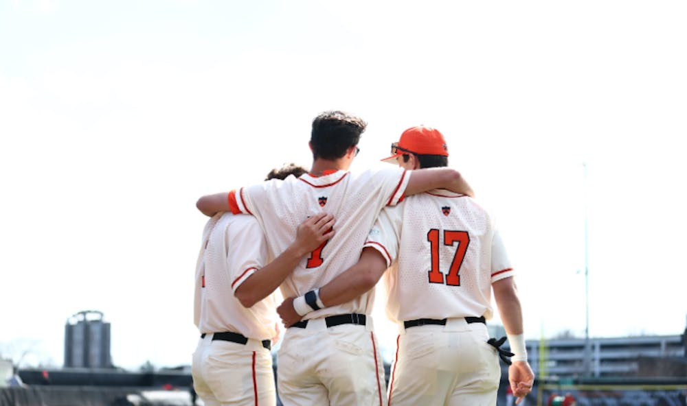 Princeton baseball players in a huddle.