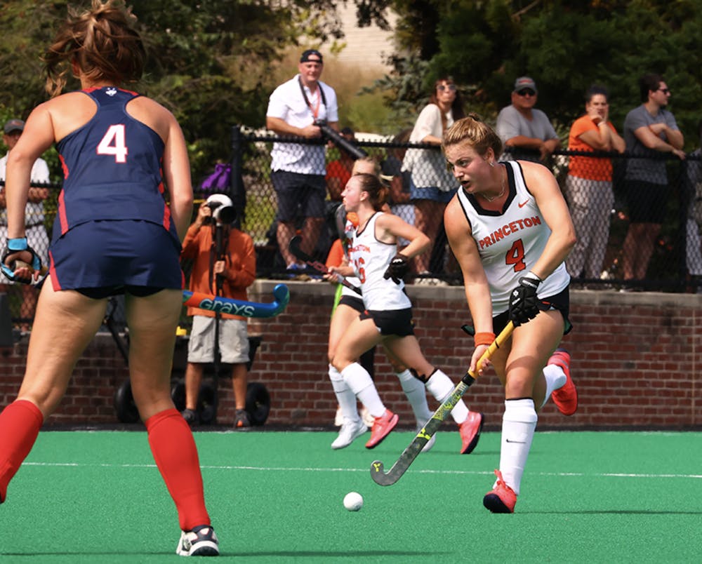 Photo of Princeton's Lily Webb, wearing a number four jersey, driving up Bedford field towards the Husky goal. 