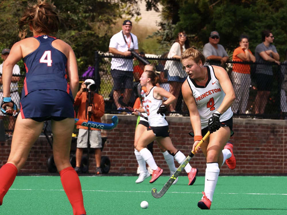 Photo of Princeton's Lily Webb, wearing a number four jersey, driving up Bedford field towards the Husky goal. 