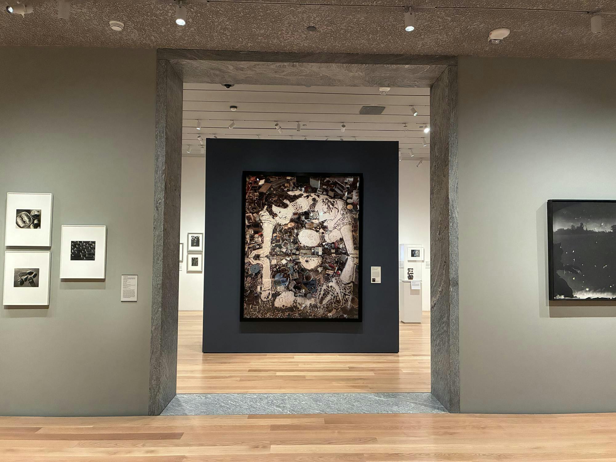 A collage of photographs displaying a person leaning over water hangs in the center of a doorway.