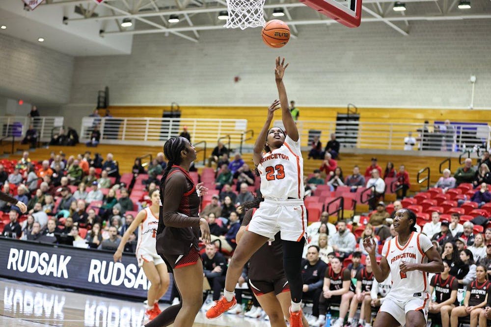 Princeton player shooting a layup.