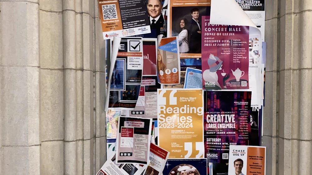 Posters of the USG president and vice president candidates are pinned on the tack board by McCosh Hall. 