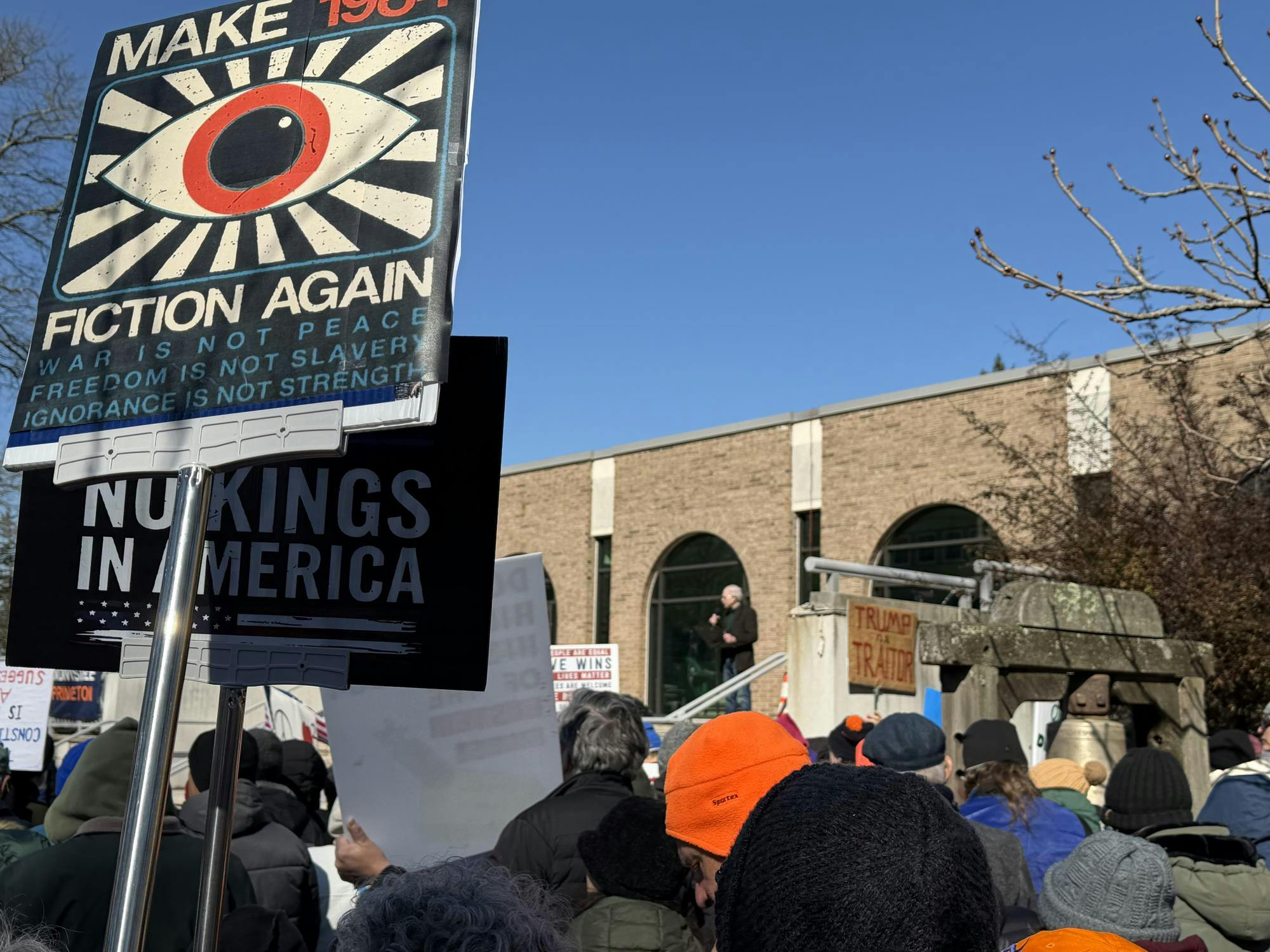 Protesters hold 'No Kings in America' signs. 
