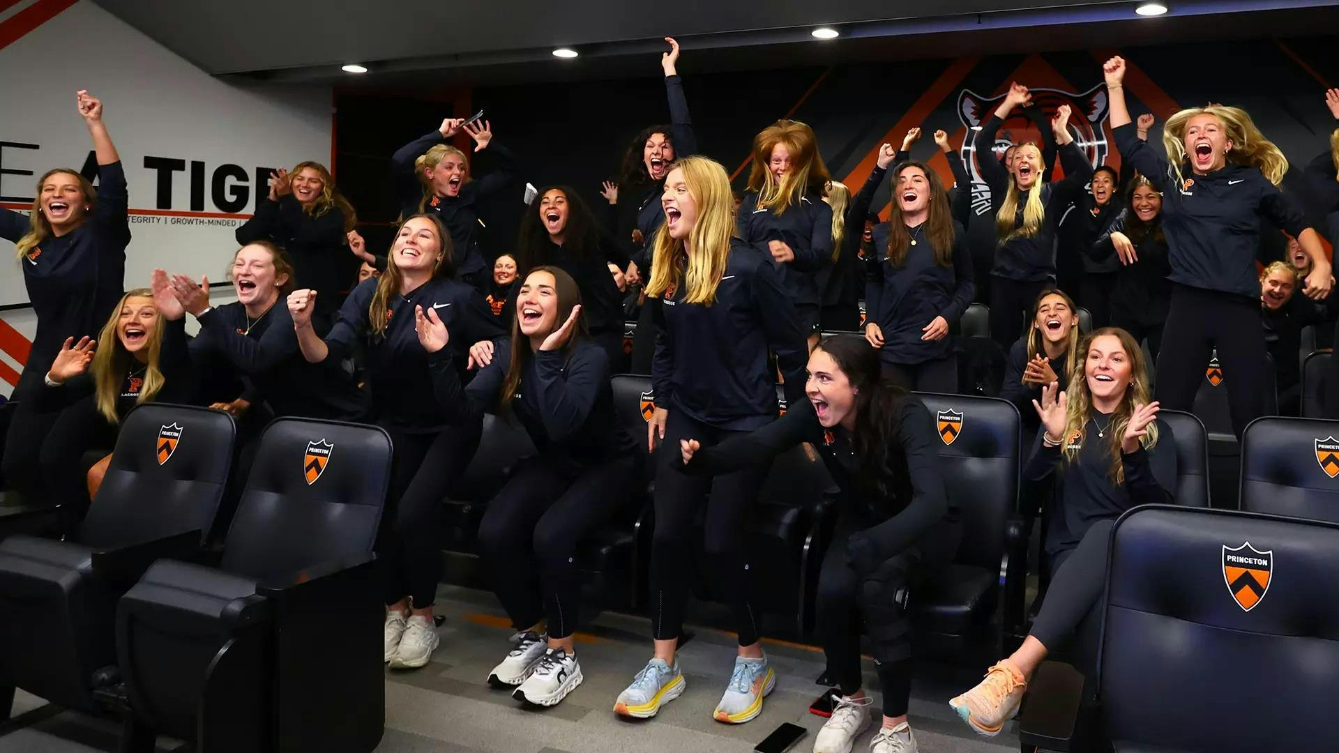 A group of women cheering in a sitting area.