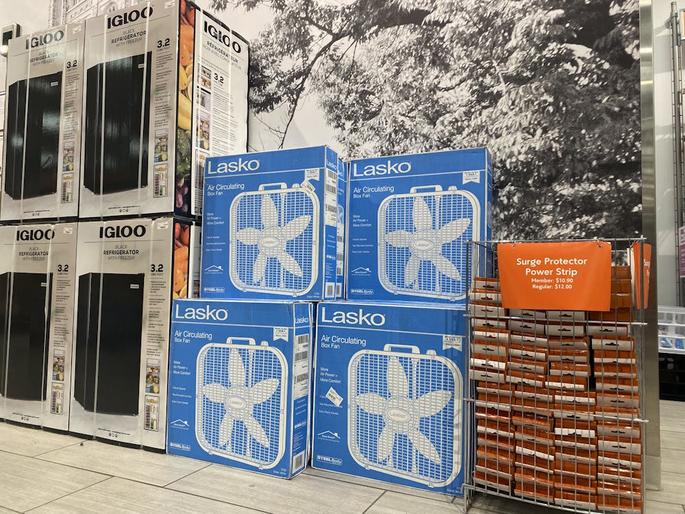  Photo of a stack of four blue boxes of box fans for sale in the Princeton University store.