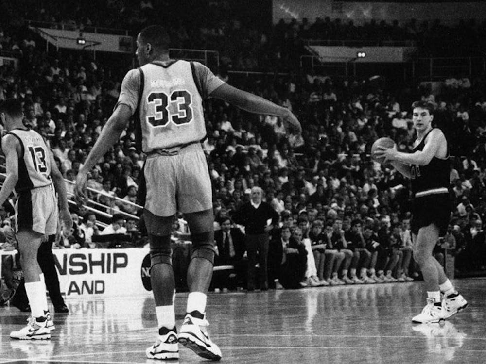 Bob Scrabis ‘89 (#34) and Kit Mueller ‘91 (#00) orchestrate the offense in Princeton’s 1989 NCAA tournament game against Alonzo Mourning (#33) and the Georgetown Hoyas. Courtesy of GoPrincetonTigers.com.