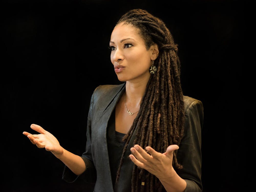 A woman gestures with her hands as she speaks during a talk.