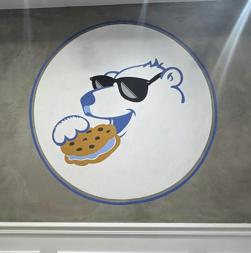 Logo of a white polar bear with blue outline. 