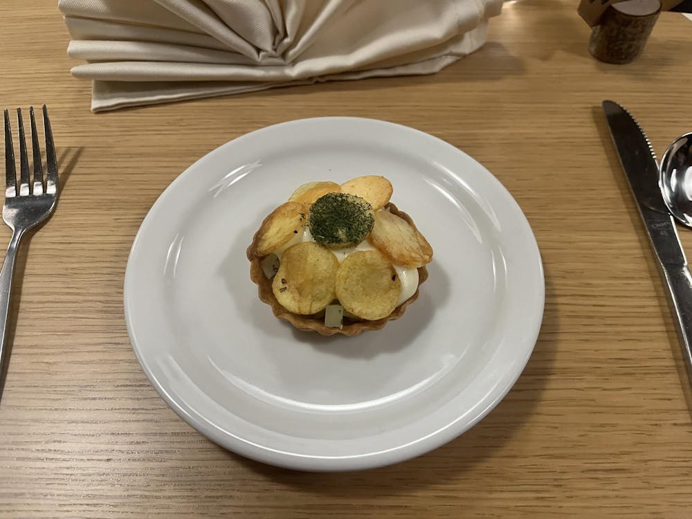 A tan pastry with tan pear slices.