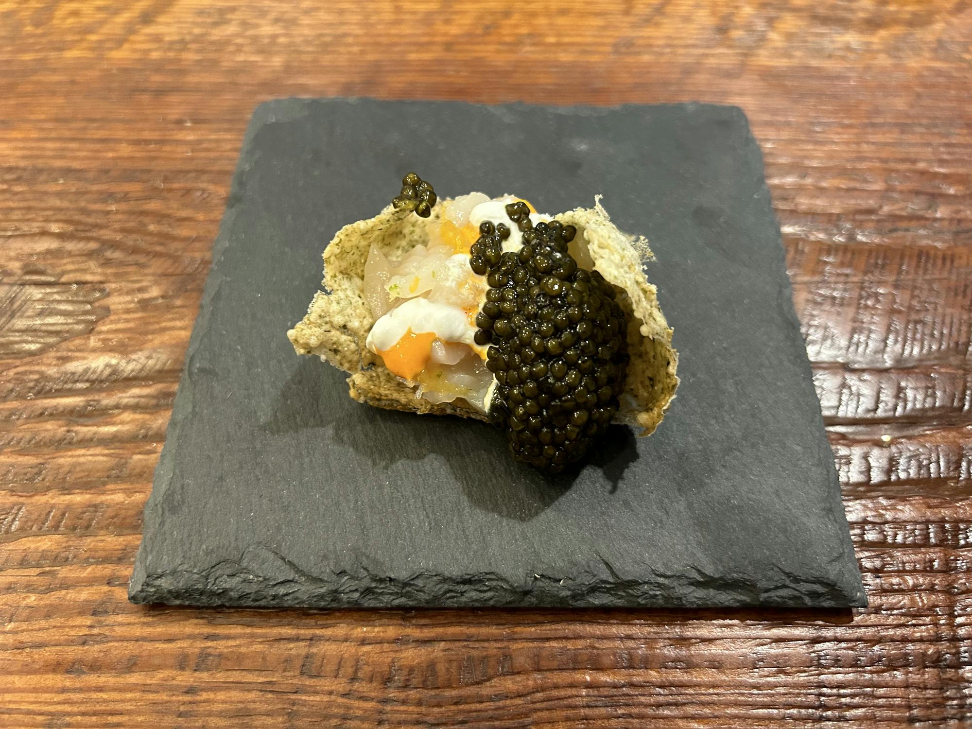 Nori chip with scallop tartare, caviar, and pepper aioli and creme fraiche. 