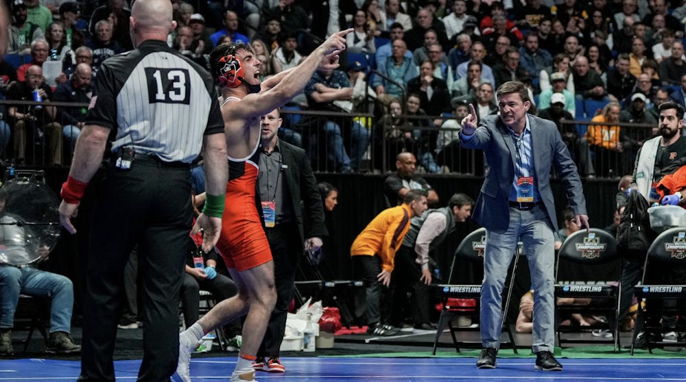 Pat Glory directs his celebratory screams toward his head coach Chris Ayers and the crowd after securing a spot in the 2023 NCAA wrestling title match.