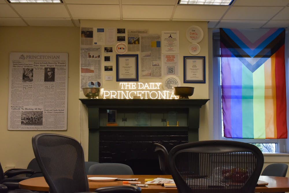 A mantle and wall covered in newspapers and news paraphernalia.