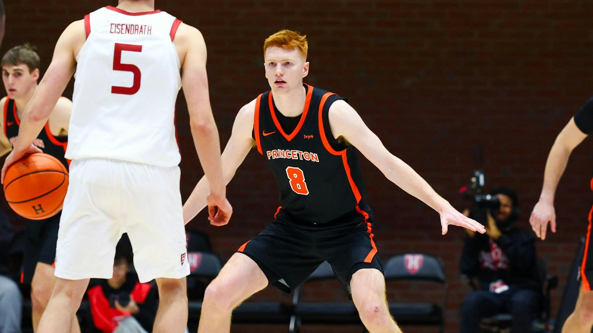Princeton defender in a black jersey spreads his arms.