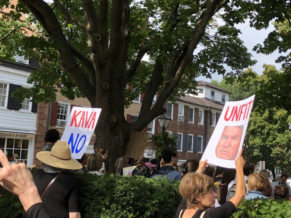 Protestors hold signs opposing Kavanaugh