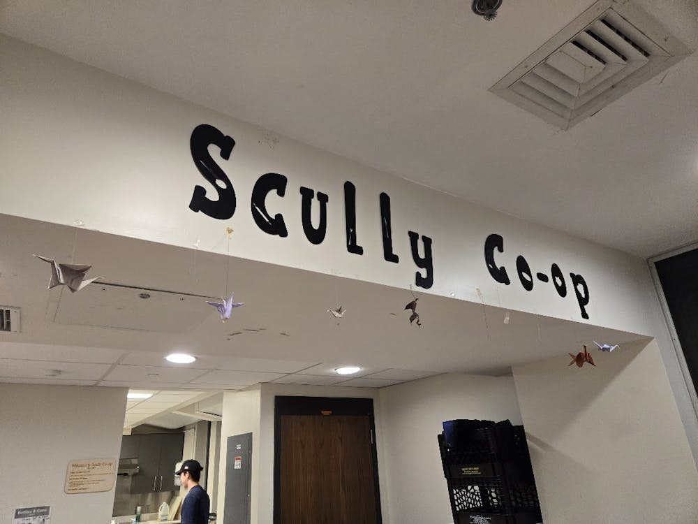 A white room with the sticker letters spelling out “Scully Co-op” on the top.