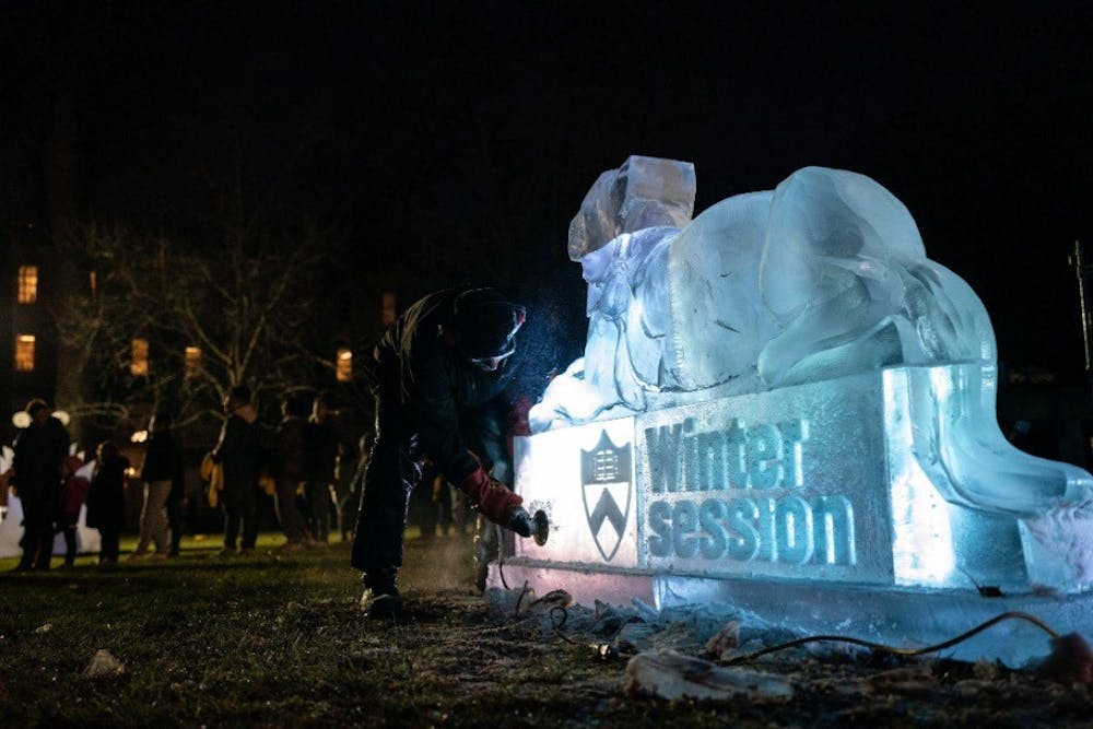 An ice sculpture of a tiger with the words "Winter session" on it.
