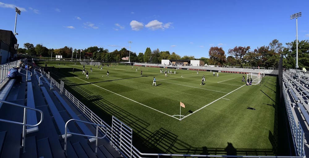 Photo of a soccer stadium with players on it 