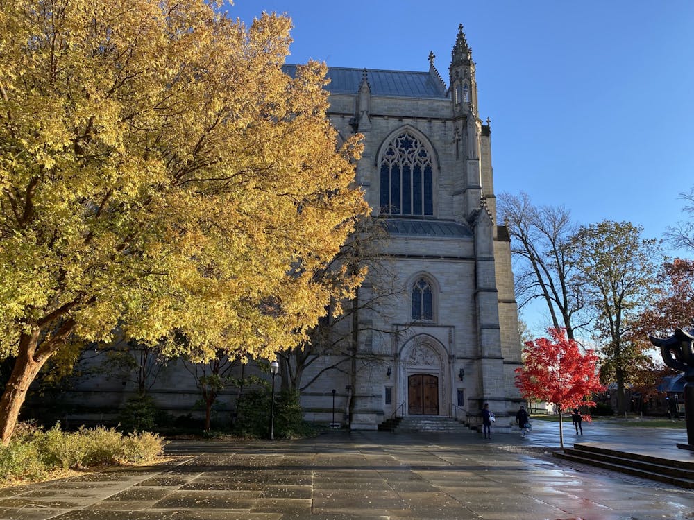 In Firestone Plaza, a bright yellow tree stands next to the chapel.