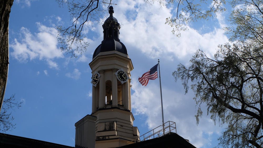 An American flag and the top of a building against the sky.