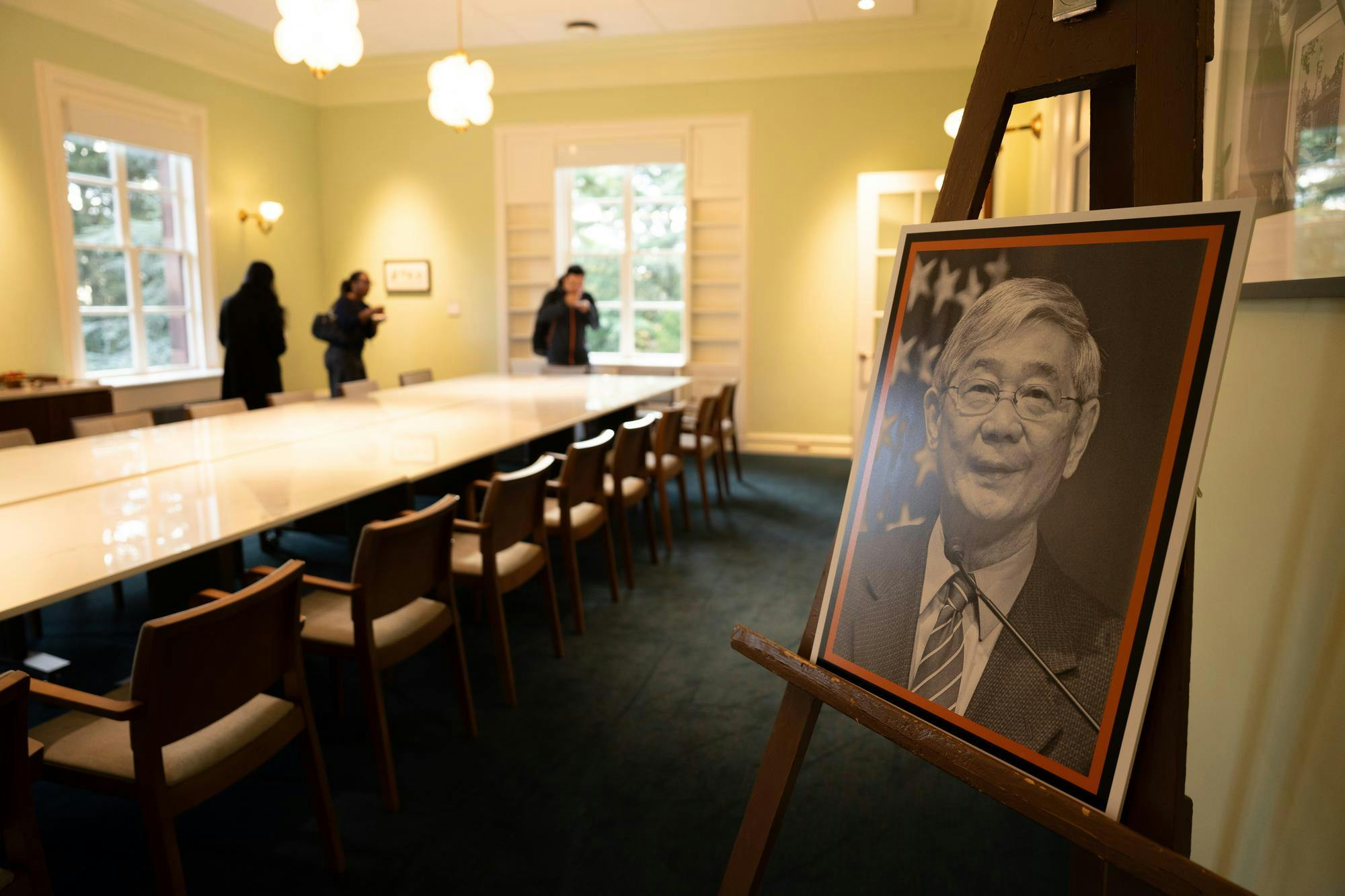 A portrait of a man on an easel in a bright meeting room in a newly renovated room.
