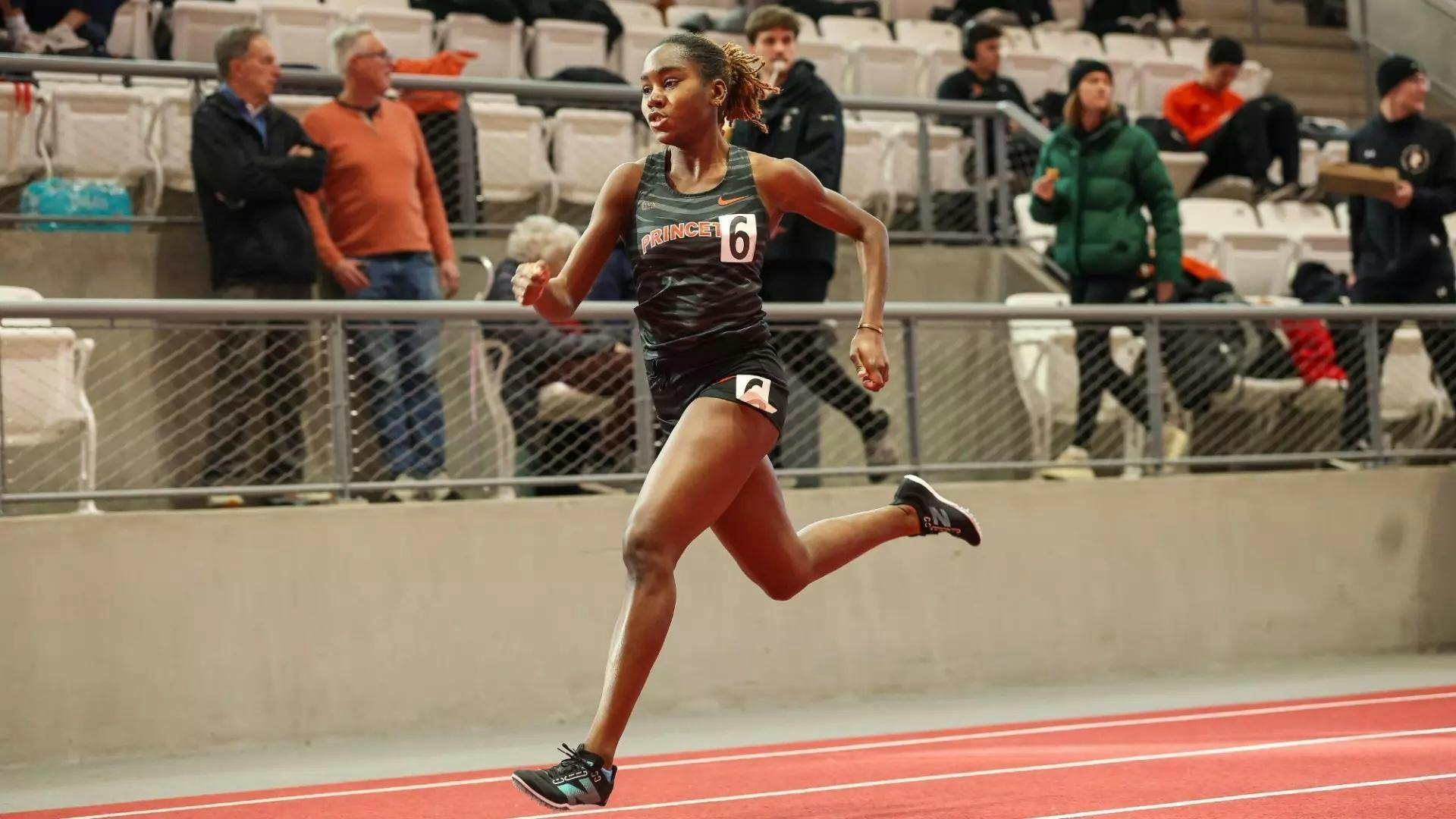 Princeton runner in black track singlet sprints on a track.