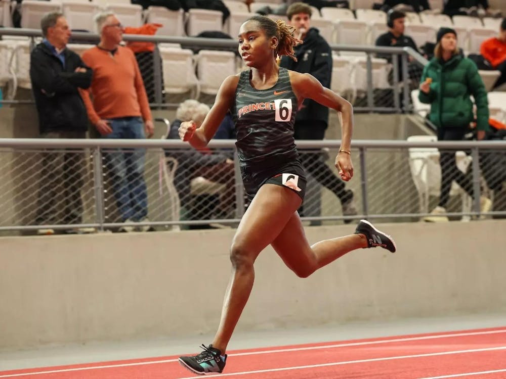 Princeton runner in black track singlet sprints on a track.