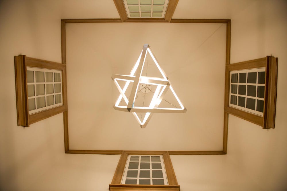 A light fixture of two triangular prisms. 