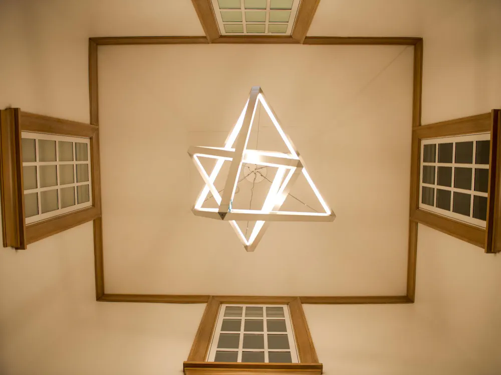 A light fixture of two triangular prisms.