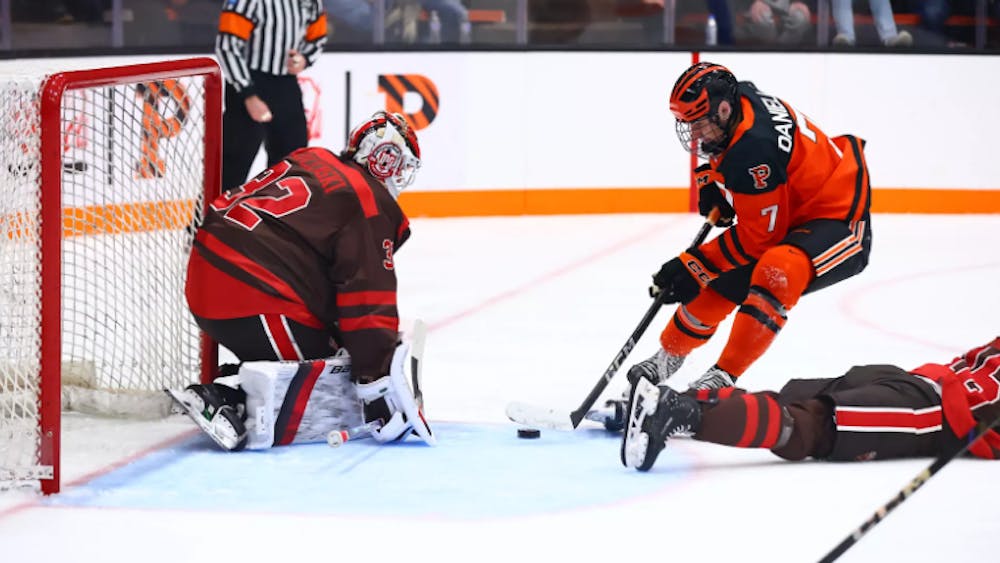 Princeton ice hockey player going to goal.
