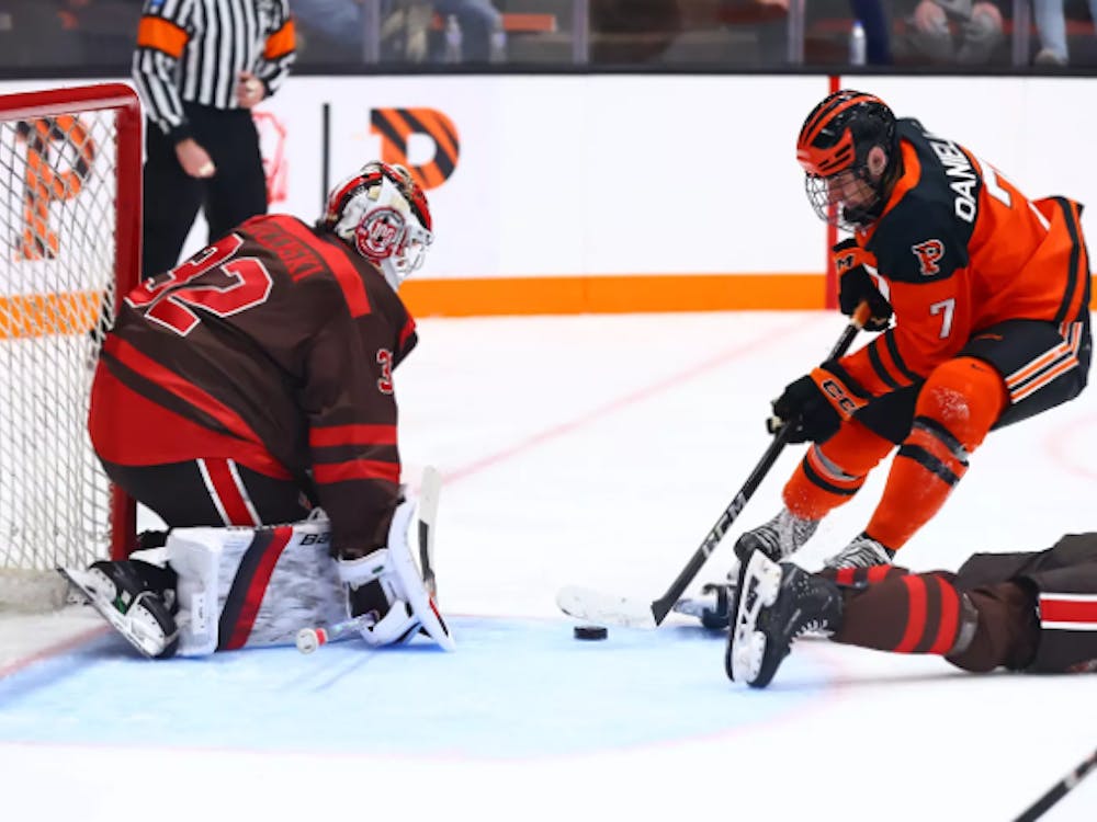 Princeton ice hockey player going to goal.