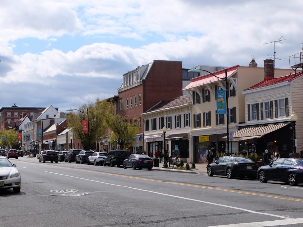 A street with cars parked on the sides.
