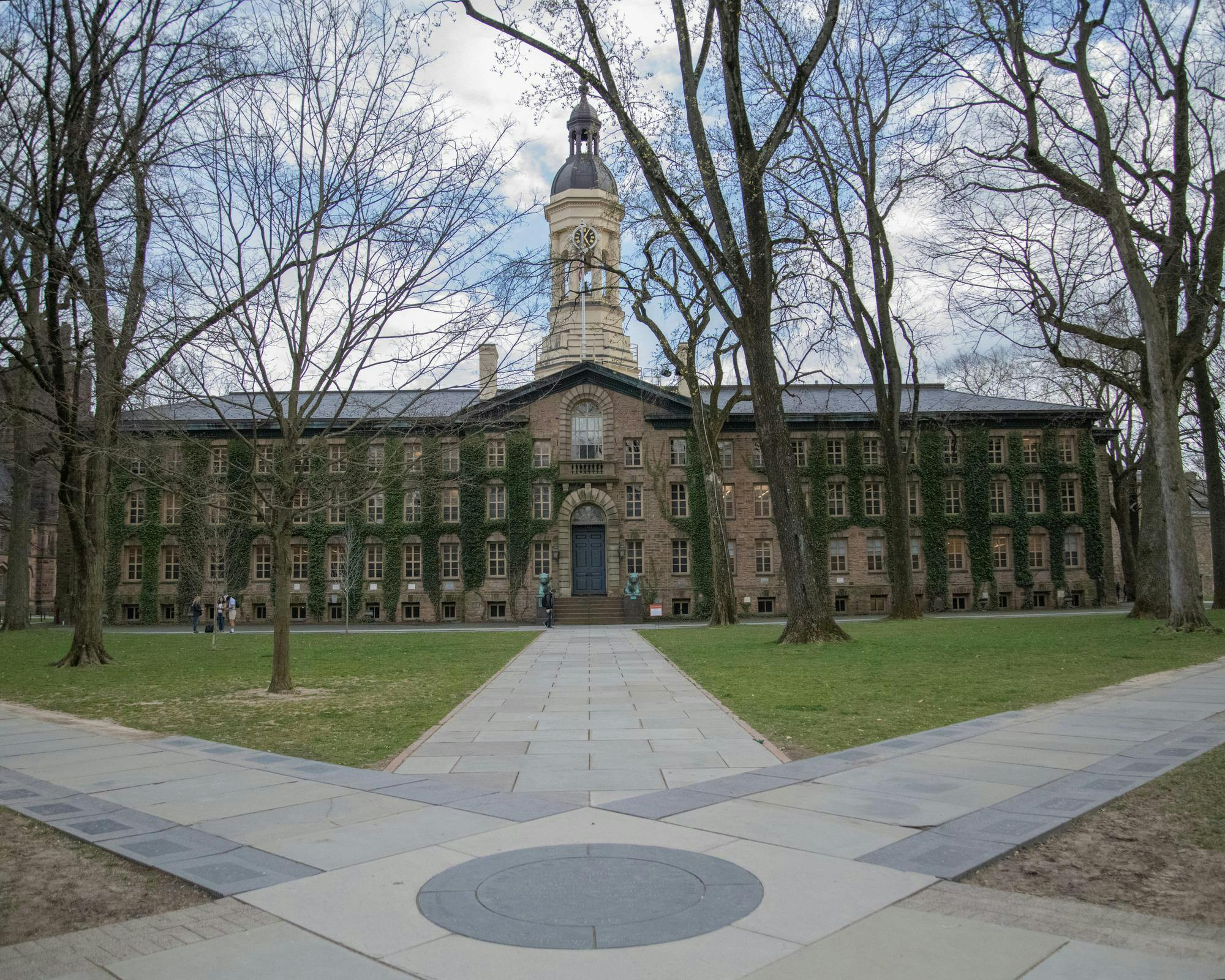 Three paths diverge from one point. In the center is an ivy covered building.