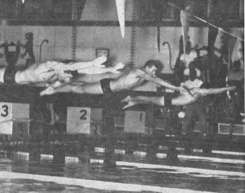 three men dive into water to begin race in 1964