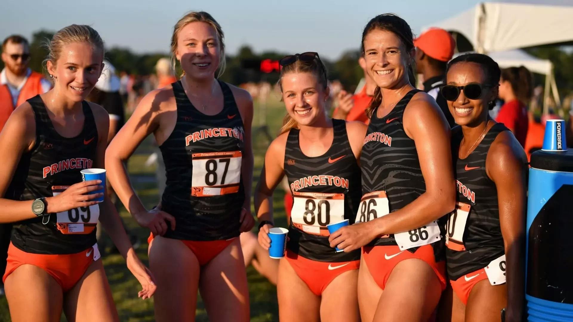 Five smiling women in cross country uniforms.